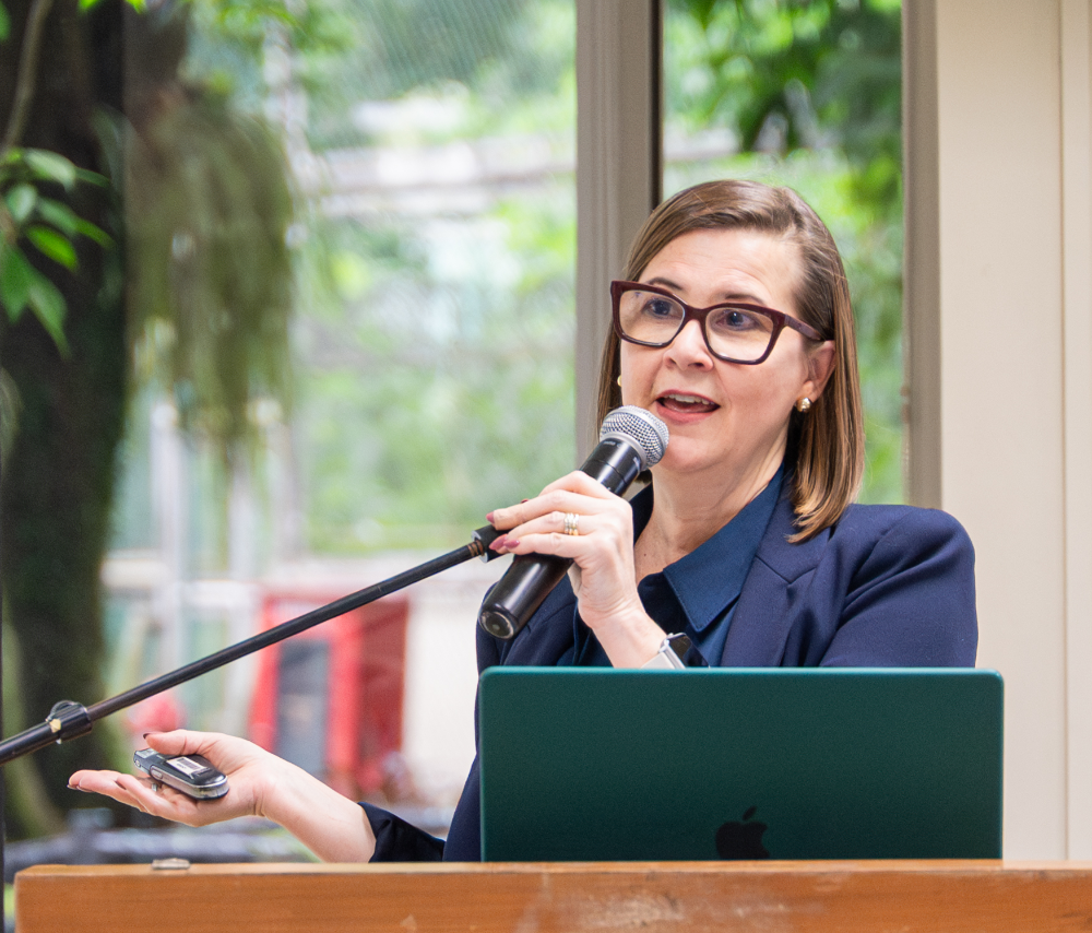 Jan Burkins presenting with a microphone
